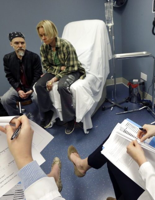 In this May 11, 2016 photo, University of Massachusetts Medical School nursing student Morgan Brescia, right, and others attend a simulation of treatment for a patient coping with addiction during class at the medical school in Worcester, Mass. Many U.S. medical schools are expanding their training to help students fight opioid abuse. New training programs at many schools teach students to prescribe opioid painkillers only as a last resort, and to evaluate all patients for signs of drug abuse. (AP Photo/Elise Amendola)